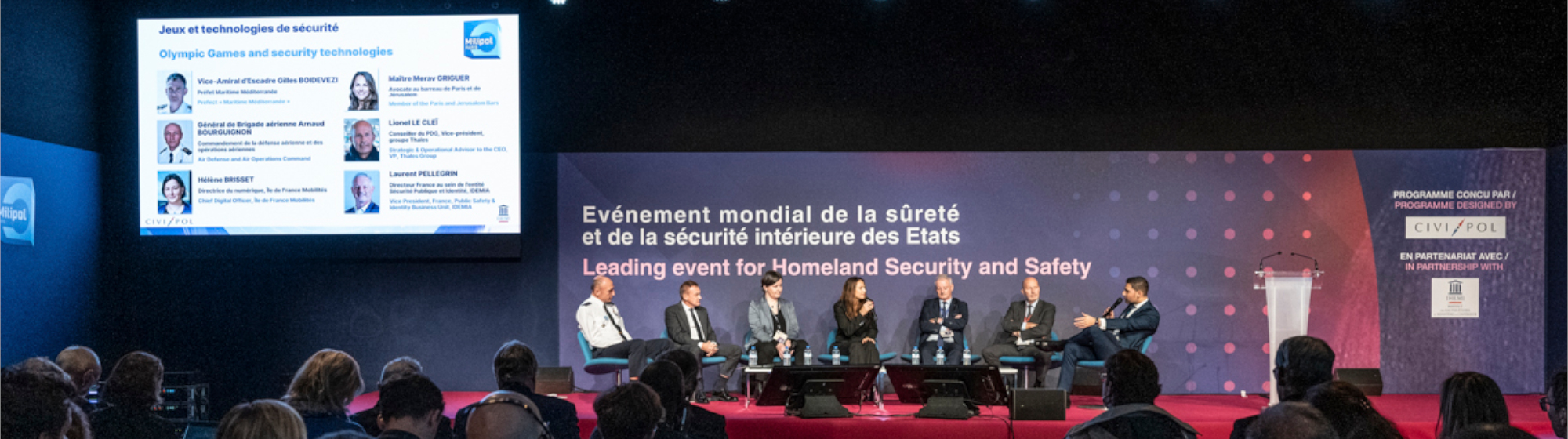 Conference on homeland security with experts on stage during Milipol Paris with a large audience.