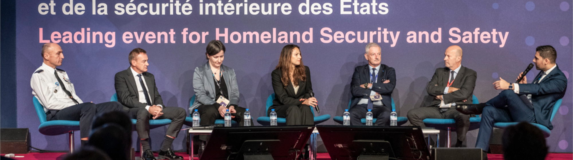 Speakers on stage during a roundtable at Milipol Paris
