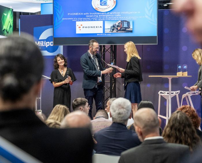 Winner of a Milipol Innovation Awards receiving the trophy on stage from the organiser, in front of attendees