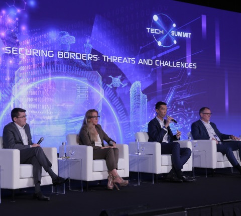 4 men seated on stage in the conference room at the Milipol Asia Pacific event
