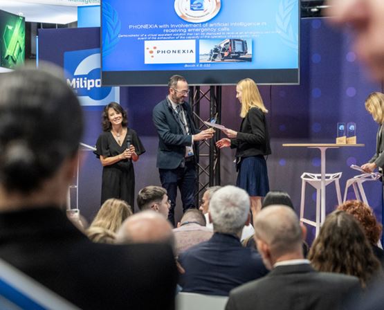 Winner of a Milipol Innovation Awards receiving the trophy on stage from the organiser, in front of attendees