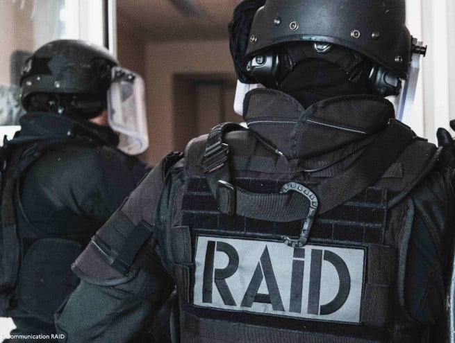 Arm of a RAID policeman with logo